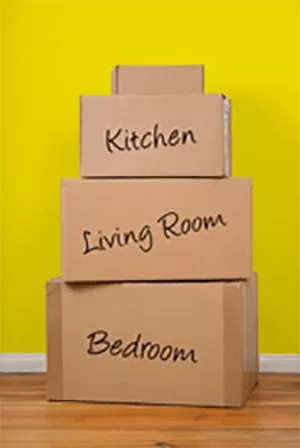 Stack of labeled moving boxes of kitchen, living room and bedroom