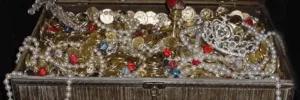 Box of gold coins, ruby colored stones and white pearl necklaces that must be stored properly to avoid moving day theft