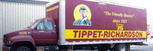 Red color Tippet-Richardson moving truck parked in front of a storage facility
